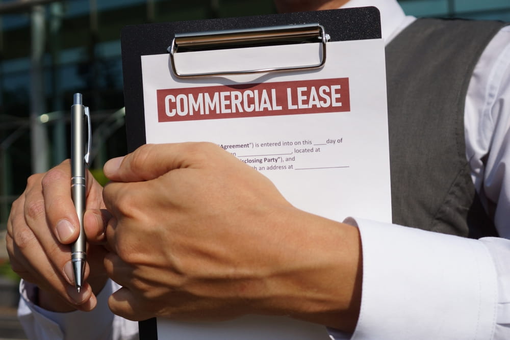Business owner reviewing commercial lease contract before signing in California.