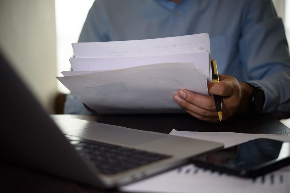 Person reviewing content license agreement documents to define usage rights and licensing terms