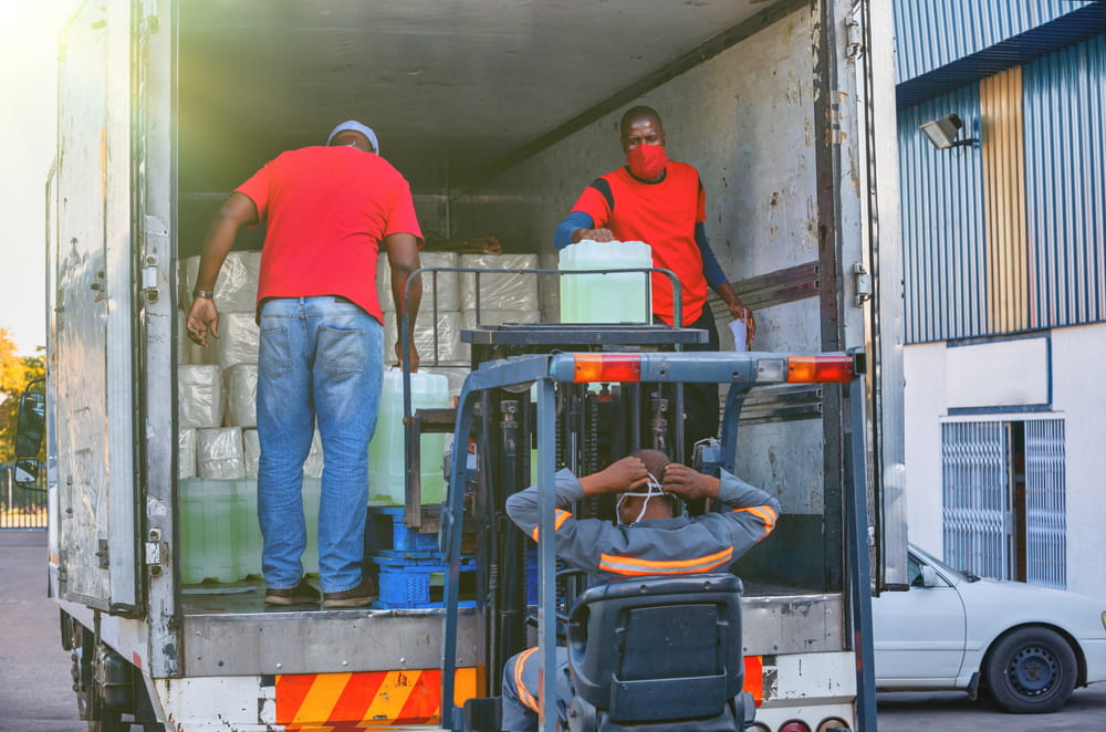 Workers unloading delivery truck illustrating shipping and delivery issues in a Florida supplier dispute